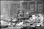 Men in suits dumping rubbish from van during bin strike